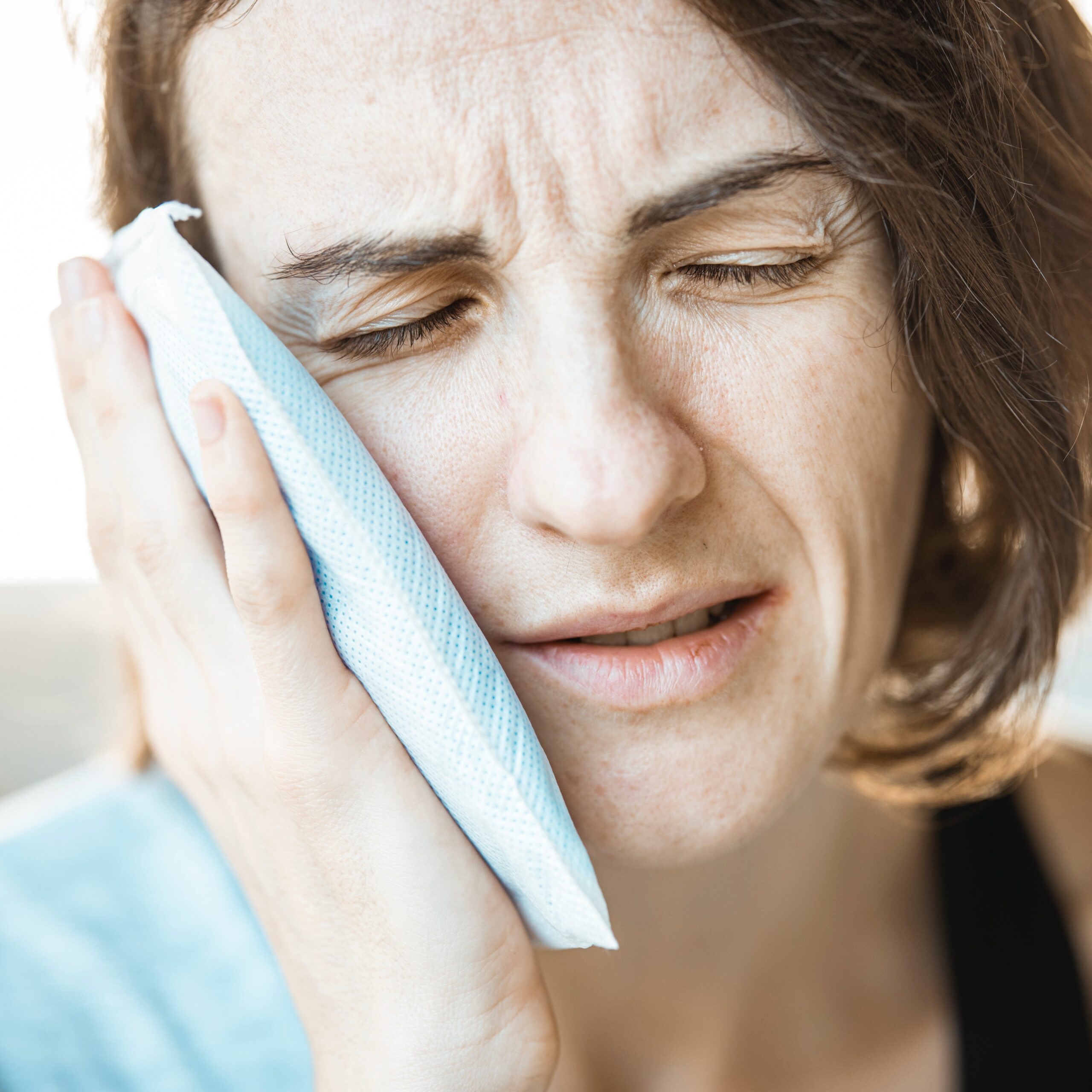 Woman experiencing a dental emergency with severe pain